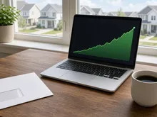Laptop energy chart and utility bill envelope on a Bryan–College Station kitchen table